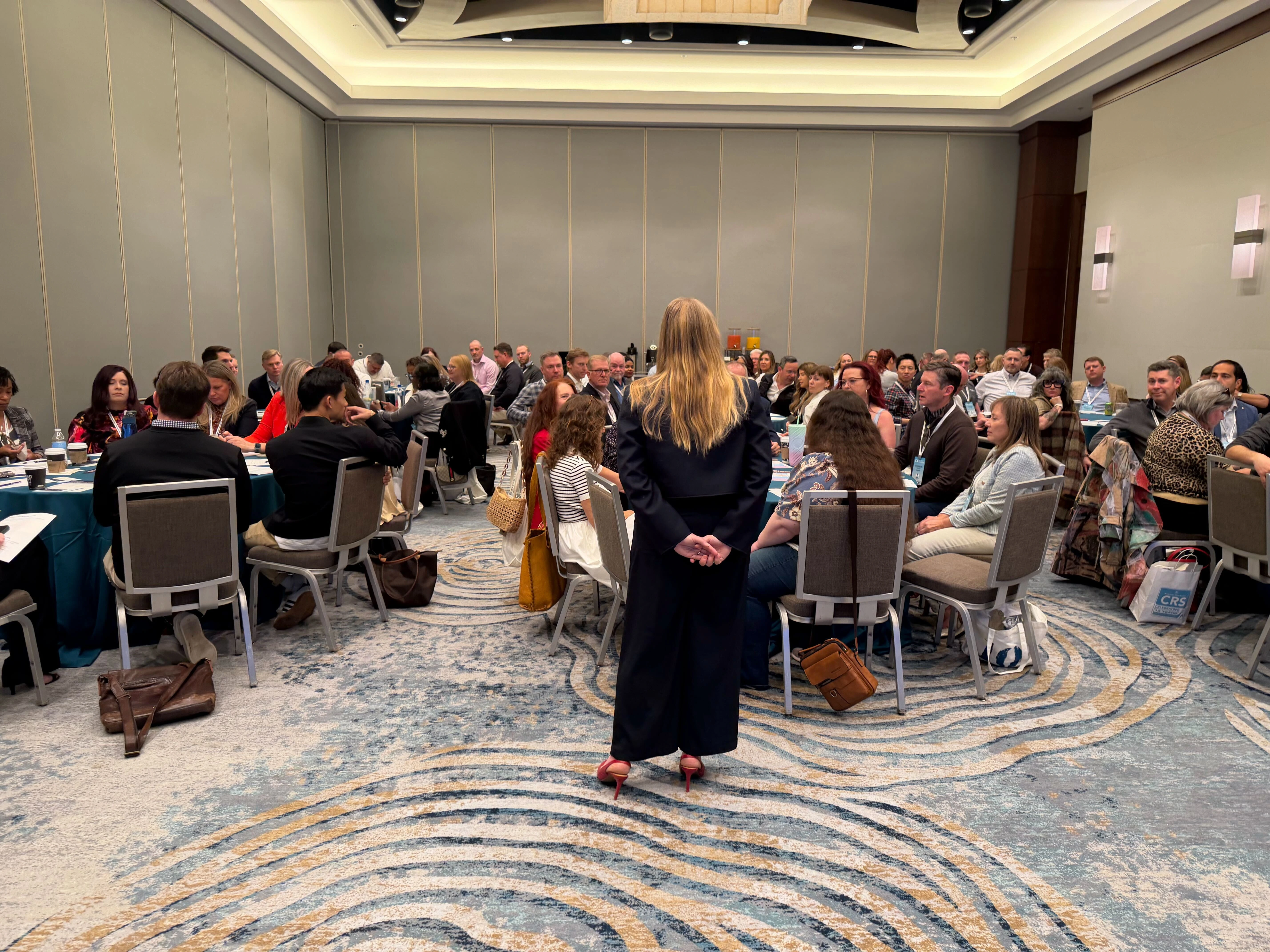 The room at CRS 2026 during the live Care Gap workshop, with Sarah Jeanneault facilitating as attendees identified structural breakdowns in their customer care operations