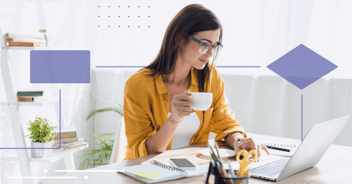 woman working on laptop from home and drinking coffee